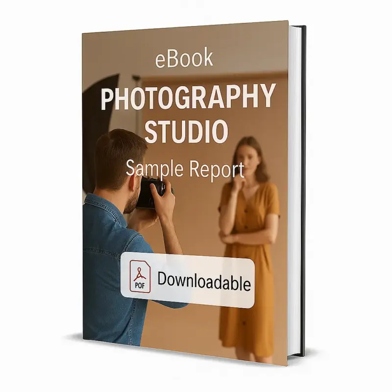 3D-rendered eBook cover for "Photography Studio Sample Report." The cover shows a young photographer in a denim shirt taking a photo of a woman posing in a beige studio with professional lighting equipment visible. The title text reads “eBook PHOTOGRAPHY STUDIO Sample Report” in bold white font, and a PDF icon with the word “Downloadable” appears at the bottom.