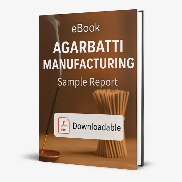 3D-rendered eBook cover for "Agarbatti Manufacturing Sample Report." The cover shows incense sticks neatly arranged in a bundle, with one incense stick lit in a wooden holder emitting gentle smoke. The background is warm and earthy. The title text reads “eBook AGARBATTI MANUFACTURING Sample Report” in bold white font, and a PDF icon with the word “Downloadable” is displayed at the bottom.