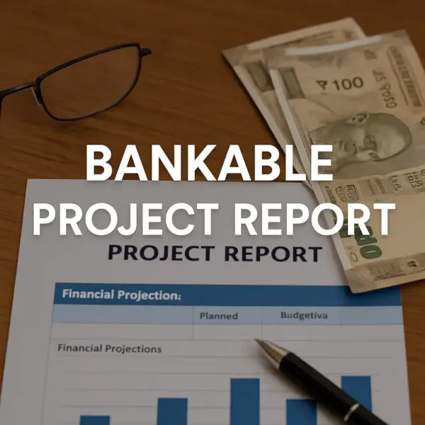 Professional workspace with a bankable project report document showing financial projections, Indian currency notes, eyeglasses, and a pen on a wooden desk, with the centered text 'BANKABLE PROJECT REPORT' in bold white letters.