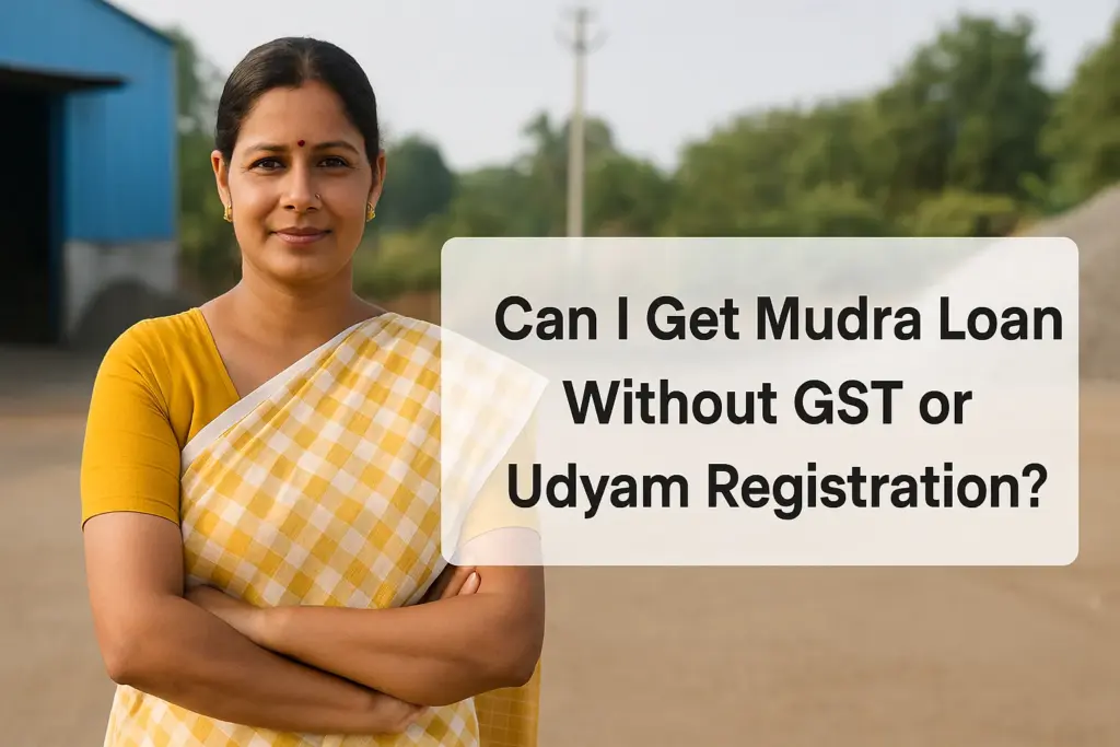 An Indian woman in a yellow and white sari stands confidently outside a small industrial unit, with a clean semi-transparent text box beside her reading “Can I Get Mudra Loan Without GST or Udyam Registration?” The background features a blue-roofed warehouse, gravel, and greenery, symbolizing micro-enterprise in a rural or semi-urban setting.