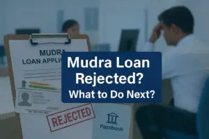 A Mudra Loan application form with an Aadhaar card and a red "REJECTED" stamp, alongside a bank passbook, with a stressed man sitting in the background—highlighting the concept of Mudra Loan rejection and the need for guidance on next steps.
