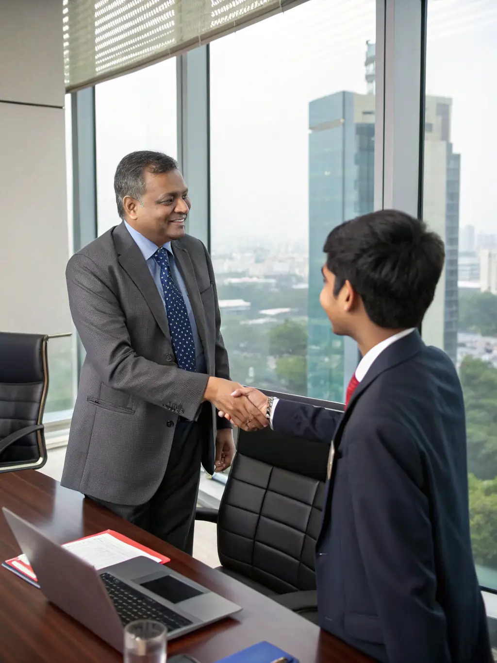 A successful business owner shaking hands with CA Manish Gugliya, symbolizing a successful project report leading to business growth.