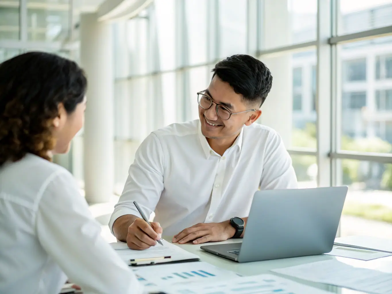CA Manish Gugliya consulting with a client in a modern office setting, emphasizing personalized guidance and support.