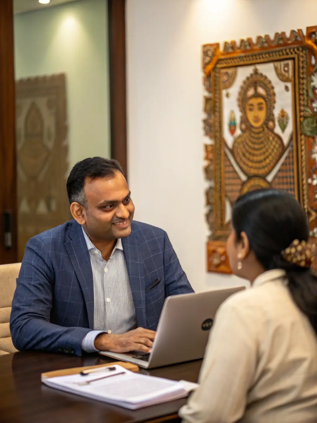 A confident, experienced Chartered Accountant in formal attire reviewing a detailed business project report at a modern desk, symbolizing professional expertise and financial acumen for Mudra Loan applicants.